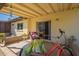 Covered patio with outdoor seating, a bicycle, and views of the landscaped yard at 131 N Higley Rd # 41, Mesa, AZ 85205