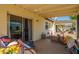 Covered patio with cozy seating, a bicycle, and views of the landscaped yard at 131 N Higley Rd # 41, Mesa, AZ 85205
