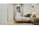 Bright and inviting bedroom with large windows, a cozy bed with decorative pillows, and a stylish nightstand, offering comfort at 1385 W Ridge Rd, Apache Junction, AZ 85120