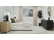 A serene bedroom features a white bed, stylish furnishings, and soft natural light, creating a relaxing and inviting atmosphere at 1385 W Ridge Rd, Apache Junction, AZ 85120