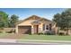 Charming single-story home featuring a well-manicured lawn, neutral colors, and a two-car garage at 1385 W Ridge Rd, Apache Junction, AZ 85120