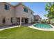 Inviting backyard with pool, artificial turf, and covered patio at 15562 W Cameron Dr, Surprise, AZ 85379