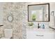 Charming powder room featuring floral wallpaper, decorative mirrors, and a stylish vanity for added elegance at 15562 W Cameron Dr, Surprise, AZ 85379