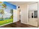 Bright bedroom showing an open doorway, scenic mural on wall, and rich hardwood floors at 15562 W Cameron Dr, Surprise, AZ 85379