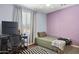 Comfortable bedroom with natural light, gaming pc, and minimalist decor at 15562 W Cameron Dr, Surprise, AZ 85379