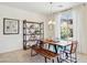 Bright dining area with a natural wood table, bench seating, and modern shelving at 15562 W Cameron Dr, Surprise, AZ 85379