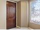 Inviting foyer with decorative window and wood door providing an abundance of natural light at 15562 W Cameron Dr, Surprise, AZ 85379