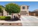 Charming exterior with a well-kept lawn and colorful flowering bushes, complemented by desert landscaping at 15562 W Cameron Dr, Surprise, AZ 85379