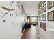 Hallway leading to open living area, featuring stylish decor and hardwood flooring at 15562 W Cameron Dr, Surprise, AZ 85379