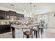 Bright kitchen with granite countertops, stainless steel appliances, and bar stool seating at 15562 W Cameron Dr, Surprise, AZ 85379