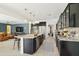Open kitchen featuring dark cabinetry, stainless steel appliances, and a center island with seating at 15562 W Cameron Dr, Surprise, AZ 85379