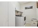 Laundry room with front load washer/dryer and plenty of cabinet space at 15562 W Cameron Dr, Surprise, AZ 85379