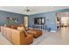 Comfortable Gathering room with neutral tile flooring, blue accent wall and a plush sectional sofa at 15562 W Cameron Dr, Surprise, AZ 85379