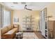 Cozy living room showcasing a comfortable leather couch, modern shelving, and natural light at 15562 W Cameron Dr, Surprise, AZ 85379