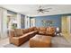 Stylish Gathering room with tile flooring, blue accent wall and a spacious sectional sofa at 15562 W Cameron Dr, Surprise, AZ 85379