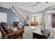 Welcoming living room featuring tile floors, a staircase, and an open layout at 15562 W Cameron Dr, Surprise, AZ 85379