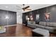 Inviting living room with a modern ceiling fan, hardwood floors, and unique wall art for a touch of character at 15562 W Cameron Dr, Surprise, AZ 85379
