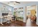 Bright home office featuring built-in shelving, modern furnishings, and a functional workspace at 15562 W Cameron Dr, Surprise, AZ 85379
