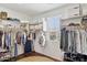 Spacious walk-in closet with custom shelving, hanging racks, and natural light for organized storage at 15562 W Cameron Dr, Surprise, AZ 85379