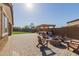 Backyard featuring a pergola with a grill, fire pit, and an artificial grass area with playground equipment at 15740 W Washington St, Goodyear, AZ 85338