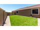 The backyard features artificial turf and a private fenced-in area, perfect for outdoor activities at 15740 W Washington St, Goodyear, AZ 85338