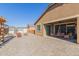 Large backyard with a paved patio area, pergola, sheds, and chairs for outdoor relaxation and entertainment at 15740 W Washington St, Goodyear, AZ 85338