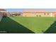 Spacious backyard featuring a playground, a pergola, a manicured lawn, and privacy wall at 15740 W Washington St, Goodyear, AZ 85338