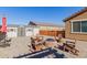 Backyard featuring a storage shed, fire pit with Adirondack chairs, and well-maintained hardscape at 15740 W Washington St, Goodyear, AZ 85338