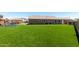 Wide view of the backyard, featuring artificial turf, outdoor play area, and extended patio at 15740 W Washington St, Goodyear, AZ 85338