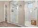Modern bathroom featuring a glass shower with elegant tile work and a neutral color palette at 15740 W Washington St, Goodyear, AZ 85338