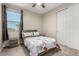 Cozy bedroom with soft carpet, a ceiling fan, and natural light from a window at 15740 W Washington St, Goodyear, AZ 85338