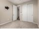 Neutral carpeted bedroom featuring closet and open doorway at 15740 W Washington St, Goodyear, AZ 85338
