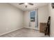 Neutral carpeted bedroom features a ceiling fan and a large window at 15740 W Washington St, Goodyear, AZ 85338