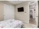 Neutral bedroom featuring carpet and sliding closet doors, with view into hallway at 15740 W Washington St, Goodyear, AZ 85338