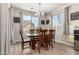 Sunlit dining room with wood table, chairs, and modern chandelier at 15740 W Washington St, Goodyear, AZ 85338