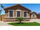 Attractive single-story home showcasing stone accents, multiple windows, and desert-friendly landscaping at 15740 W Washington St, Goodyear, AZ 85338