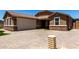 Lovely house with brick driveway, two-car garage, and stone facade detail at 15740 W Washington St, Goodyear, AZ 85338