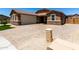 Beautiful home with brick driveway, two-car garage, and stone facade detail at 15740 W Washington St, Goodyear, AZ 85338