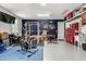 Spacious home garage equipped with gym equipment, storage shelving, and work area at 15740 W Washington St, Goodyear, AZ 85338