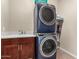 Efficient laundry room featuring stacked washer and dryer units and ample counter space at 15740 W Washington St, Goodyear, AZ 85338