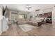 Bright living room featuring tile floors, a ceiling fan, access to backyard and an open kitchen at 15740 W Washington St, Goodyear, AZ 85338