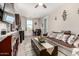 Open-concept living room with kitchen access, a comfortable sofa, and stylish decor at 15740 W Washington St, Goodyear, AZ 85338