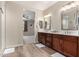 Main bathroom boasts double sinks, wood cabinets and lots of light at 15740 W Washington St, Goodyear, AZ 85338