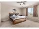 Cozy main bedroom with neutral tones and a ceiling fan at 15740 W Washington St, Goodyear, AZ 85338
