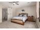 Comfortable main bedroom featuring a sliding barn door to the en-suite bathroom at 15740 W Washington St, Goodyear, AZ 85338