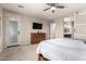 Main bedroom featuring door to patio, dresser, and ceiling fan at 15740 W Washington St, Goodyear, AZ 85338
