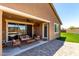 Covered patio with outdoor seating and ceiling fan, perfect for relaxation and entertaining at 15740 W Washington St, Goodyear, AZ 85338