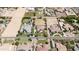 Aerial view showcases the neighborhood with ample lot sizes and custom home designs in the community at 16386 W Papago St, Goodyear, AZ 85338