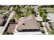 Aerial view of desert home showcasing tile roof, lush landscaping, and a charming, well-manicured yard at 16386 W Papago St, Goodyear, AZ 85338
