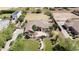 Stunning property featuring a home with a manicured lawn, mature trees, and a charming stone-detailed entrance at 16386 W Papago St, Goodyear, AZ 85338